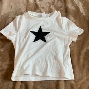 White shirt with black leather star.
